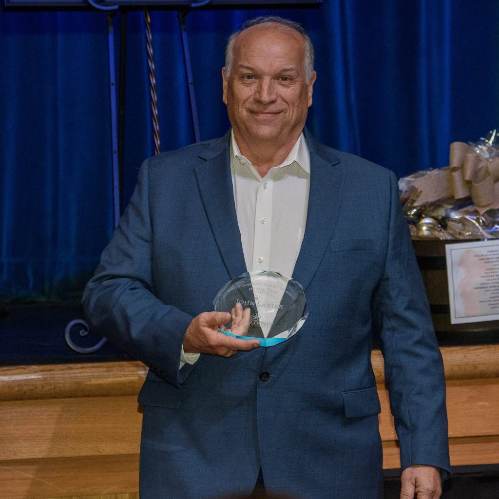 John Lanier holds the Wise County Chamber of Commerce Outstanding Board Member of the Year award at the Winter Wonderland & Awards Gala